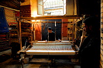 A man working at a carpet loom. Medina quarter, Fes, Morocco, December 2010.