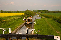 Longboat entering lock on the Aylesbury arm of the Grand Union Canal, near Tring, Hertfordshire, UK