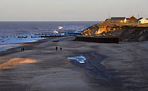 Broken sea wall caused by wave erosion and storm damage, Happisburgh, Norfolk, UK, winter