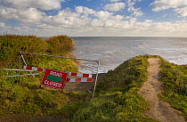 Warning sign for road / track closed due to coastal erosion, Happisburg, Norfolk, UK