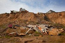 Remains of building destroyed in cliff collapse due to coastal erosion, Happisburgh, Norfolk, UK, March 2009