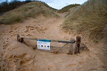 Gate and path buried by drifting sand, Norfolk, UK