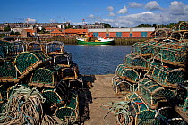 Lobster pots stacked up on harbour, Whitby, Yorkshire, UK