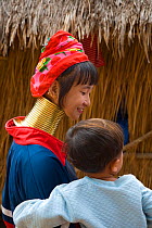 Kayan woman wearing brass coils around her neck to lower the cavicle and make the neck look longer, Thailand 2009