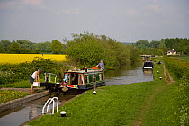 Narrow boat passing through a lock on the Grand Union Canal, Marsworth, Hertfordshire, UK
