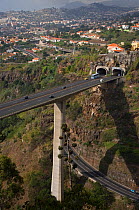 Aerial view of dual carriageway road carried by bridge high over a valley, near Funcal, Madeira, November