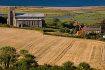 Salthouse church and village with farmland in the foreground and grazing marshes in the background, Norfolk, UK, August