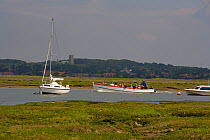 Boat taking tourists out to see the seals on Blakeney Point, Morston Quay, Norfolk, UK, July