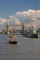 Thames barge on River Thames with Tower Bridge and HMS Belfast in the background, London, UK, September 2006