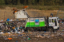 Council refuse lorry dumping household waste in landfill site in disused quarry, Norfolk, UK, October