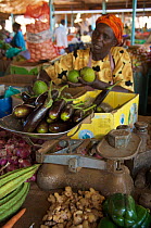 African woman selling fruit and vegetables at the market in Masindi. Masindi, Uganda, Africa. December 2006