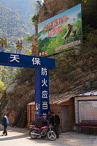 Signpost with Golden snub-nosed monkey at the entrance to Zhouzi Nature Reserve, Shaanxi, China. March 2006