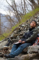 Dr. Zhao Qing observing Golden snub-nosed monkeys (Rhinopithecus roxellana qinlingensis) in Zhouzhi Nature Reserve, Qinling Mountains, Shaanxi, China, April 2006