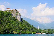Bled Castle and Succursal Church of St. Andrej overlooking Lake Bled, with the Julian Alps in the background, Bled, Slovenia, July 2010.