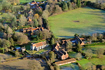 Aerial view of Wood Norton village with largely medieval All Saints church and nearby traditional houses and brick barns, near Fakenham, Norfolk, UK, January 2011.