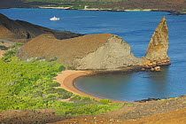 An inlet and beach on Bartholomew Island with a boat in the background. Galapagos, Ecuador, April 2010.