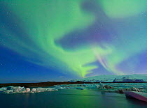 Northern lights (Aurora Borealis) in sky above Jokulsarlon glacier lagoon. Southern Iceland, Europe, March 2011.