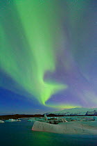 Northern lights (Aurora Borealis) in sky above Jokulsarlon glacier lagoon. Southern Iceland, Europe, March 2011.