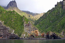 Dramatic geology with caves sheer mountain peak. Quest Bay, Gough Island, South Atlantic Islands, March 2007.