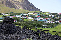 Houses in Edinburgh of the Seven Seas, the main settlement on Tristan da Cunha with solidified lava in the foreground. South Atlantic Islands, March 2007.