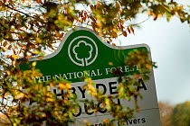 The National Forest sign for the village Ashby De La Zouch, taken through autumn foliage, The National Forest, Derbyshire, UK, November 2010
