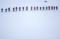 Line of mountain walkers in winter, Lochain Mountains, Cairngorms NP, Highlands, Scotland, UK, February 2010