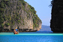 Long-tail boat and limestone cliffs. Koh Phi Phi, Thailand, December 2010.