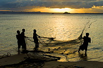 Fishermen gathering in their nets. Ramena beach, Diego Suarez (Antsiranana), north Madagascar, Africa, June 2007.