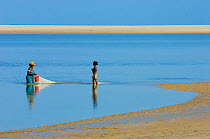 Woman and girl fishing on the beach. Morondava, Madagascar, Africa.