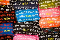 Stacks of Ibiza branded clothes. Ibiza, Balearic Islands, Spain, June.