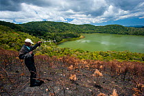 A researcher using a radio receiver to find Madagascar Pochard (Aythya innotata). Bemanevika protected area, north Madagascar, Africa, October 2010.