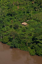 Native Indian house along the Aguarico River in Cuyabeno Reserve, seen from the air. Ecuador, June 2007.