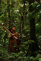 Huaorani man hunting in the forest with his blowgun. Gabaro community, Yasuni National Park, Ecuador, June 2007. Model release #GA23.