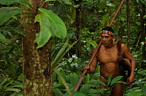 Huaorani man returning from a hunt with his primate (woolly monkey) bushmeat. Gabaro Community, Yasuni National Park, Ecuador, June 2007. Model release #GA02.