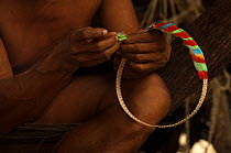 Huaorani Indian feather crown being made. Gabaro Community, Yasuni National Park, Ecuador, June 2007.