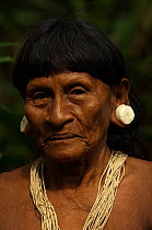 Portrait of a Huaorani Indian woman. She has the typical stretched ear lobes common amoung the Huaorani. They often wear balsa ear plugs. Gabaro Community, Yasuni National Park, Ecuador, June 2007. Mo...