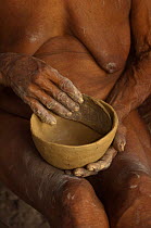 Huaorani Indian woman making a clay pot. The Huaorani clay pots have a unique shape compared with any of the other indian tribes in Ecuador. Gabaro Community, Yasuni National Park, Ecuador, June 2007....