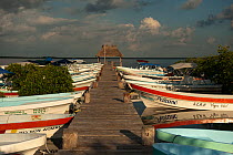 Fishing boats moored by a jetty. Punta Allen, Sian Ka'an Biosphere Reserve, Quintana Roo, Yucatan Peninsula, Mexico.