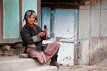 Old Monpa lady with typical head dress made from Yak hair. Arunachal Pradesh, India, February 2011.