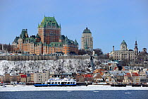 Frontenac Castle and St Lawrence river ferry boat in melting ice. Quebec, Canada, March 2011.