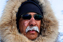 Mauris Spence, local Inuit indigenous guide for polar bear expeditions. Frost on moustache. Wapusk National Park, Churchill, Manitoba, Canada, March 2011.