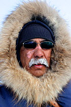 Mauris Spence, local INuit indigenous guide for polar bear expeditions. Frost on moustache. Wapusk National Park, Churchill, Manitoba, Canada, March 2011.