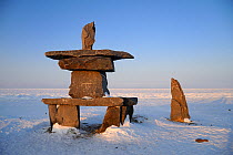 Inukshuk - an Inuit cairn - in an arctic landscape. Churchill, Hudson Bay, Manitoba, Canada, March 2011.