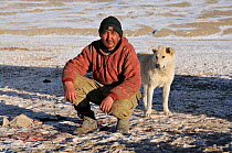 Portrait of a Kyrgyz shepherd with his dog. Naryn National Park, Kyrgyzstan, Central Asia, November 2009.