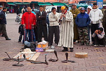 Snake charmer entertaining a small crowd. Marakesh, Morocco, March.