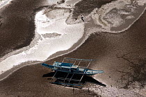 Aerial view of outrigger boats moored in the coastal mudflats, stuck at low-tide waiting for high tide, Sarangani Bay, Philippines, April 2010.