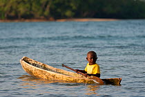 Instead of bicycles, children have dugout canoes to paddle for getting to places and to burn off energy, Marovo Lagoon, Solomon Islands, Melanesia, Pacific, July 2010.