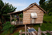 Traditional home with solar panel, Chea Village, Marovo Lagoon, Solomon Islands, Melanesia, Pacific, July 2010, a politician donated a solar panel for each household providing light for those living i...