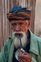 Portrait of elderly East Timorese man in traditional clothing, Maubara, East Timor, August 2010.