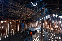 Traditional salt making - brine is boiled in a large open pan over fire of palm fronds for 8hrs, East Timor, August 2010.
